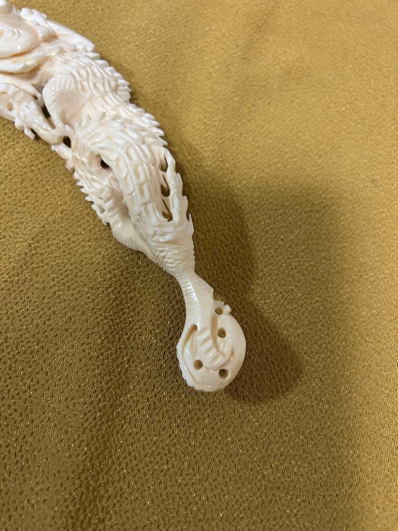 マンモスの牙や天然素材から彫られた、龍や鳳凰の精巧な透かし彫りが施された彫刻品